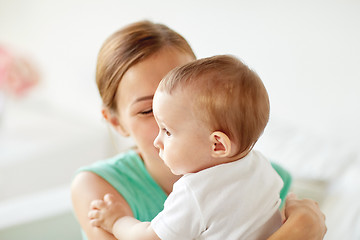 Image showing happy young mother with little baby at home