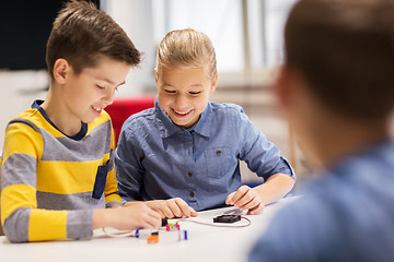 Image showing happy children building robots at robotics school