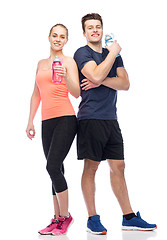 Image showing sportive man and woman with water bottles