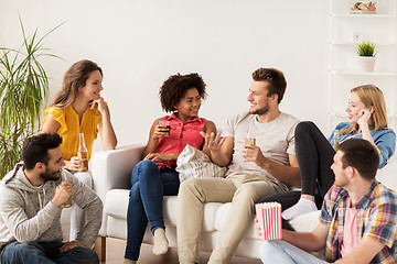 Image showing happy friends with popcorn and beer at home