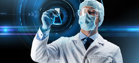 Image showing scientist in mask holding flask with chemical