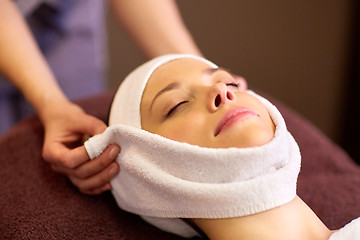 Image showing woman having face massage with towel at spa