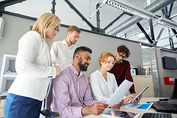 Image showing business team with tablet pc and papers at office