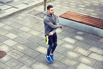 Image showing man exercising with jump-rope outdoors