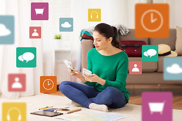 Image showing happy woman with money and travel map at home