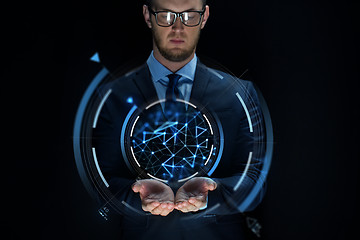 Image showing businessman with virtual projection over black