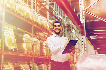 Image showing businessman with clipboard at warehouse