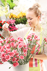 Image showing A bouquet of cut flowers course of floristic. Laying flowers. Beautiful cut flowers, florist arranges medley