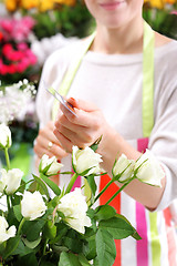 Image showing Flower containers laid a bouquet of cut flowersBeautiful cut flowers, florist arranges medley