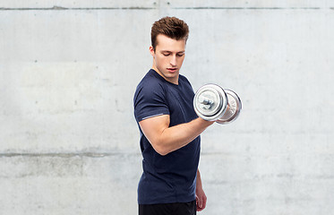 Image showing sportive man flexing muscles with dumbbell