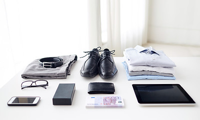 Image showing clothes, gadgets and business stuff on table