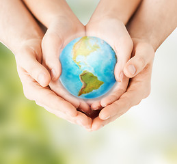 Image showing woman and man hands holding earth planet