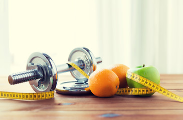 Image showing close up of dumbbell, fruits and measuring tape