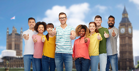 Image showing happy people showing thumbs up over london