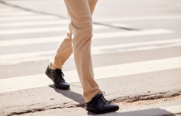 Image showing senior man walking along city crosswalk