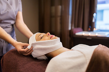 Image showing woman having face massage with towel at spa parlor