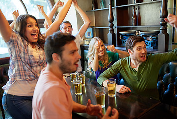 Image showing football fans or friends with beer at sport bar