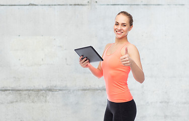 Image showing happy smiling sportive young woman with tablet pc