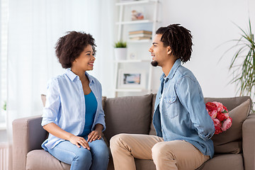 Image showing happy couple with bunch of flowers at home