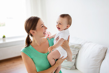 Image showing happy young mother with little baby at home