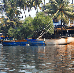 Image showing Fishing boats at the pier in palm jungles