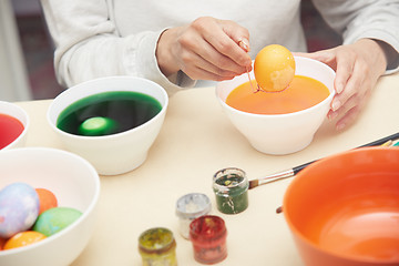 Image showing Woman preparing Easter eggs