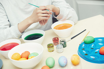 Image showing Woman preparing Easter eggs