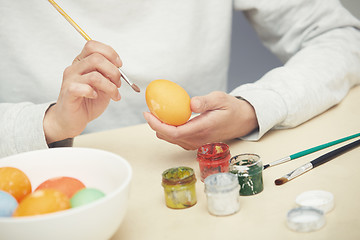 Image showing Woman preparing Easter eggs