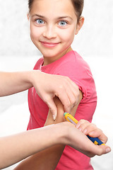 Image showing Girl with diabetes during the injections of insulin.