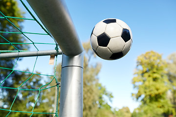 Image showing soccer ball flying into football goal net on field