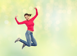 Image showing smiling young woman jumping in air