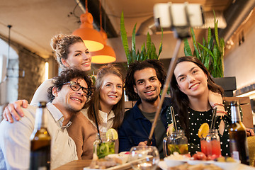 Image showing friends taking selfie by smartphone at bar or cafe