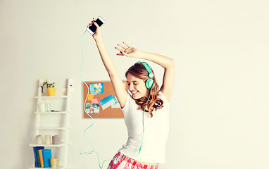 Image showing happy woman in headphones ihaving fun at home