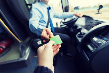 Image showing bus driver taking ticket or card from passenger