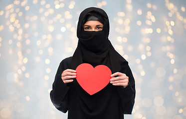 Image showing muslim woman in hijab holding red heart