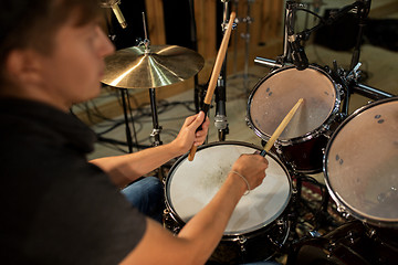 Image showing male musician playing drums and cymbals at concert