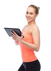 Image showing happy smiling sportive young woman with tablet pc