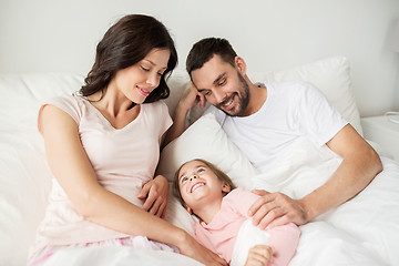 Image showing happy family in bed at home