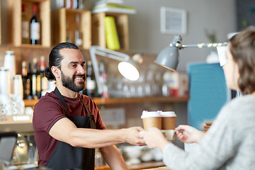 Image showing man or waiter serving customer in coffee shop