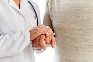 Image showing close up of doctor holding old man hand