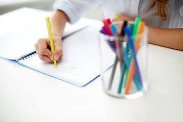 Image showing girl drawing with felt-tip pen in notebook