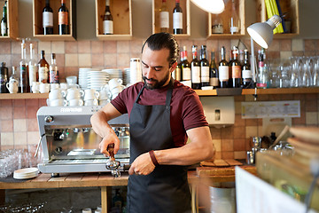 Image showing barista with holder and tamper making at coffee