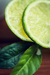 Image showing lime slices on wooden table