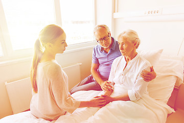 Image showing family visiting ill senior woman at hospital