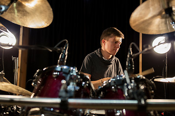 Image showing male musician playing drums and cymbals at concert