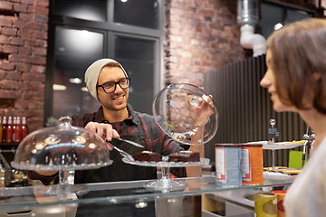 Image showing man or barman with cakes serving customer at cafe