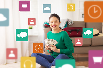 Image showing happy woman with money and travel bag at home