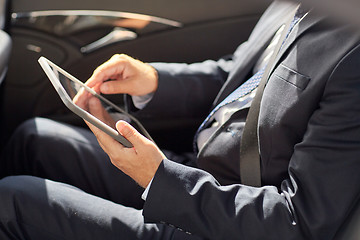 Image showing senior businessman with tablet pc driving in car