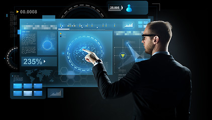 Image showing businessman pointing finger to virtual screen