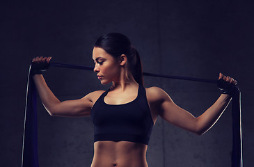 Image showing woman with expander exercising in gym